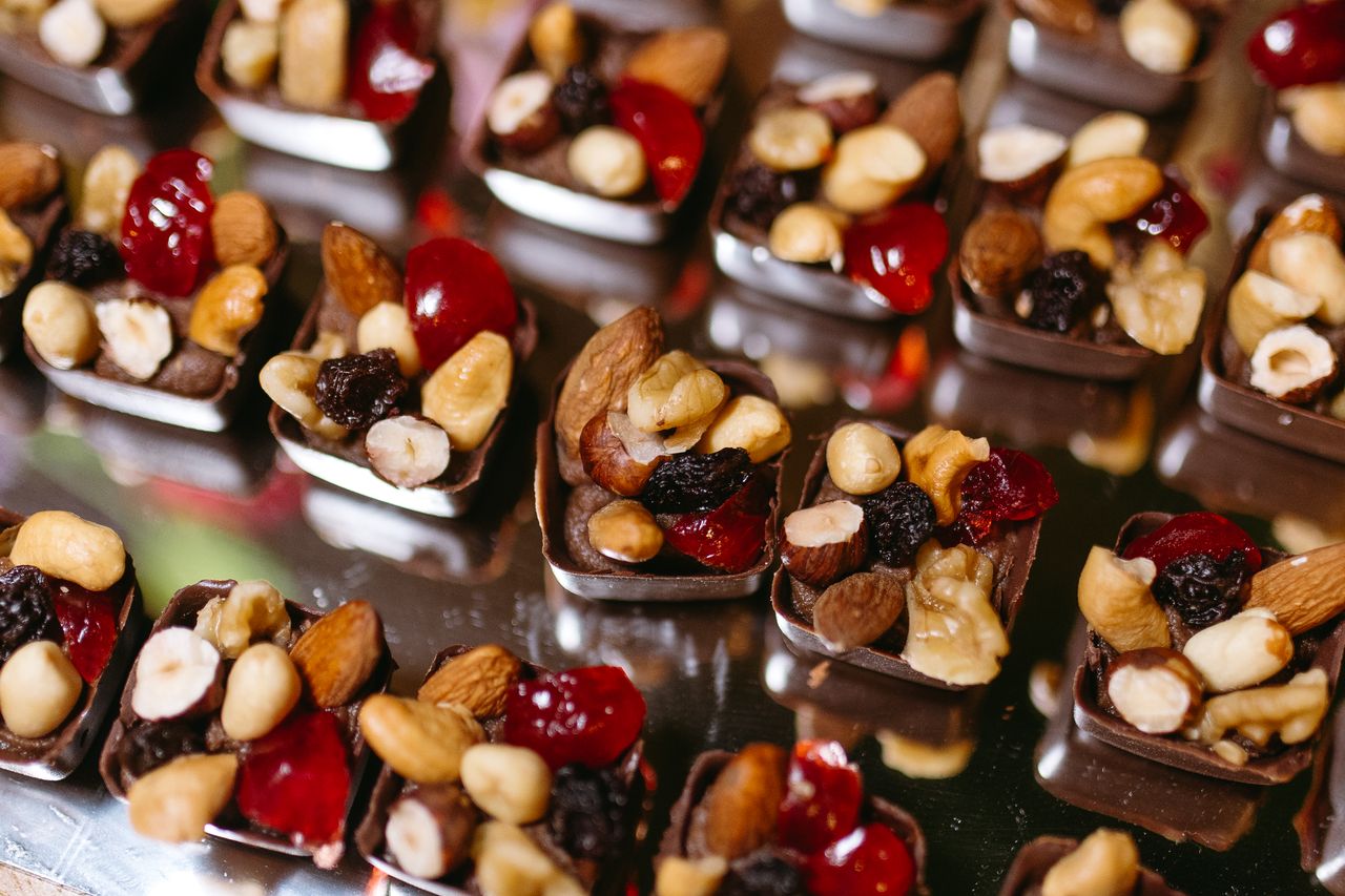 Delicious chocolate bites filled with assorted nuts and dried fruits on display.