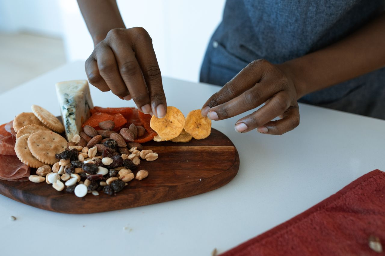 Delicious homemade charcuterie board with assorted snacks, captured indoors.
